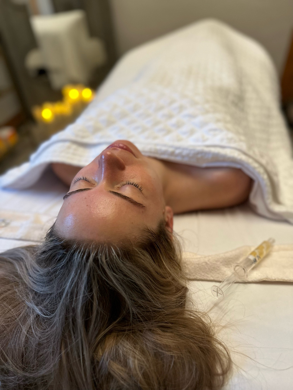 Client receiving a customized facial treatment at MLAesthetics